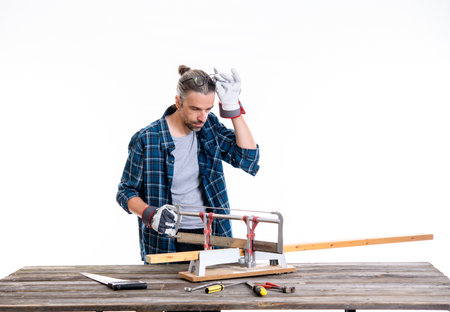 worker in blue plaid  shirt sawing woodの写真素材