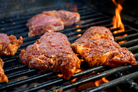 grilled pork with flames on charcoal barbecueの写真素材