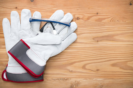 goggles and work gloves on wooden groundの写真素材
