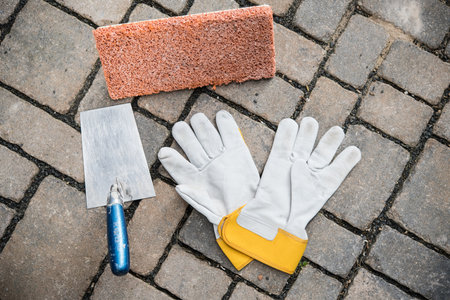  trowel, sponge board and work gloves on stone groundの写真素材