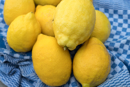 yellow lemons with blue towel on wooden groundの写真素材