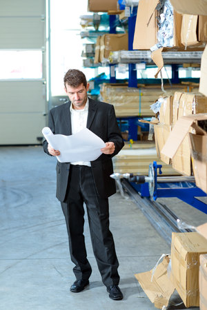 in the factory- young boss and worker in conversationの写真素材