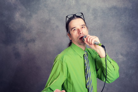young crooner in green shirt and necktieの写真素材