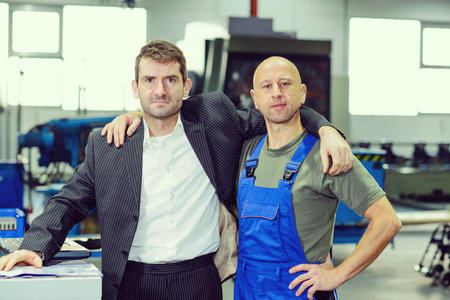 hugging-  boss and worker on work benchの写真素材