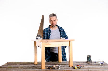 funny worker in blue plaid  shirt repair a table