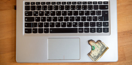 still life- computer keyboard with burned dollar bank notesの写真素材