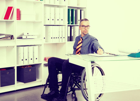 disabled business man in wheelchair working  in the officeの写真素材