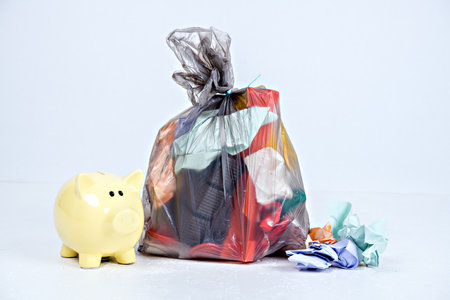 garbage bag with defferent content with yellow piggy bankの写真素材