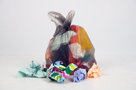 garbage bag with defferent content  in front of light backgroundの写真素材