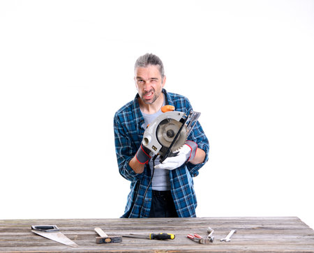 funny worker in blue plaid  shirt working with woodの写真素材