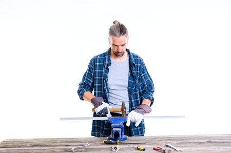 worker in blue plaid  shirt working with metalの写真素材