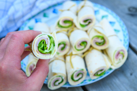 wrap with ham and salad in handの写真素材