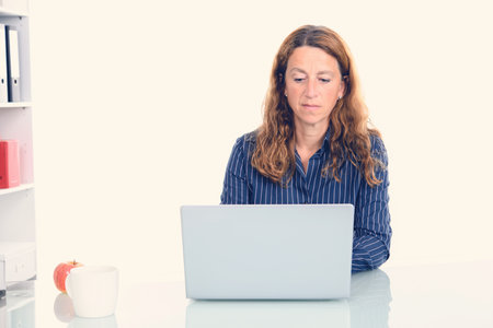 brown-haired  businesswoman working with computer in the officeの写真素材