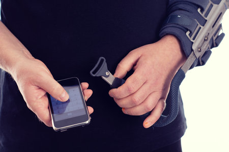man with broken arm is using smartphoneの写真素材