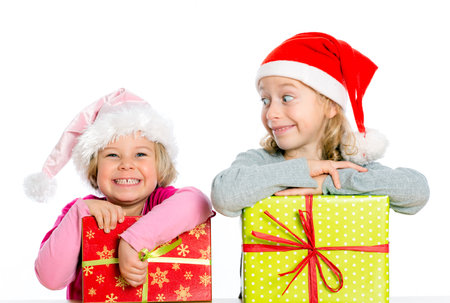 two nice girls with Santa- cap and presentの写真素材