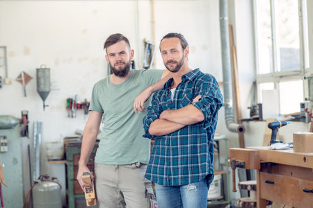 two men in workwear in a carpenter's workshopの写真素材