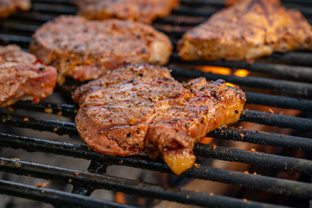 grilled pork with flames on charcoal barbecueの写真素材