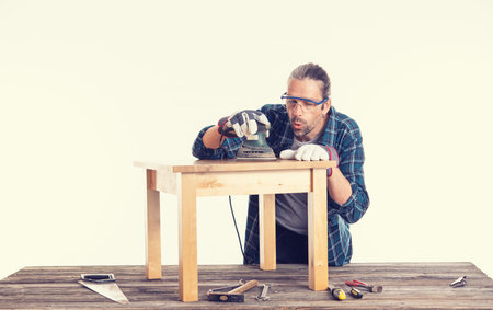 worker in blue plaid  shirt repair a tableの写真素材