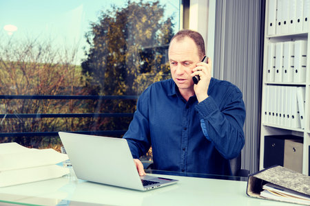 young business man at his desk workingの写真素材