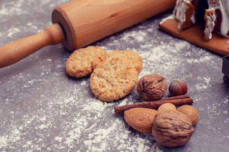 christmas decoration with rolling pin,cinnamon, nuts and cookiesの写真素材
