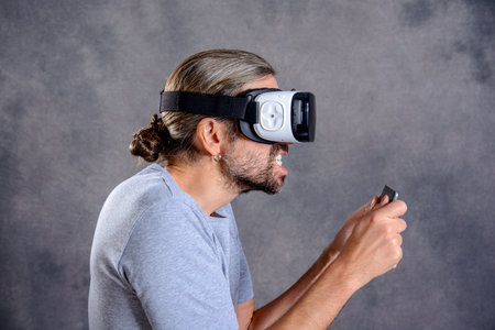 young man with virtual reality glasses playing gameの写真素材