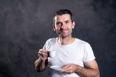 young dark haired man with espresso cupの写真素材