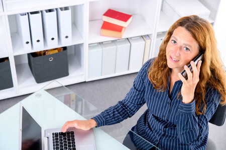 brown-haired  businesswoman working with computer in the officeの写真素材