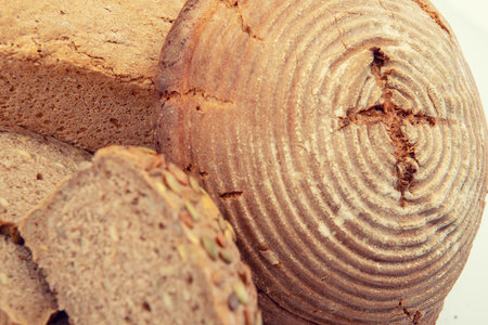 different bread in wooden bowl in front of white backgroundの写真素材