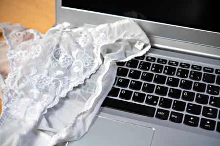 white woman panties with silver laptop- computerの写真素材
