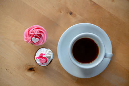 pink and white muffins  with coffee cupの写真素材