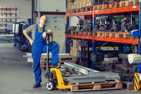 one worker in factory with hand liftの写真素材