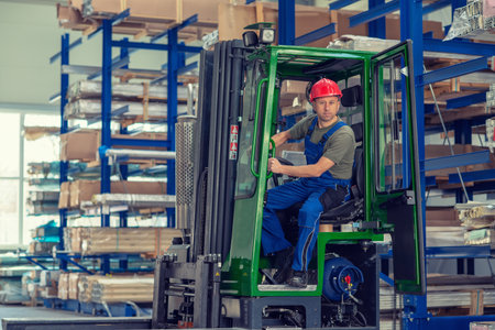 one worker in factory in lift truck with thumb upの写真素材