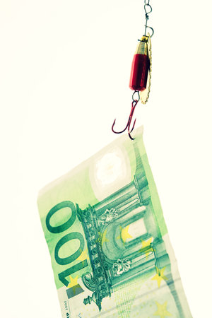 fishhook with euro note in front of white backgroundの写真素材