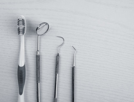 three different dental instruments and toothbrush on bright groundの写真素材