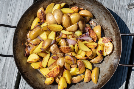 grilled potatos with onionin iron panの写真素材