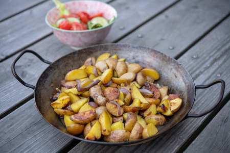 grilled potatos with onionin and salad iron panの写真素材