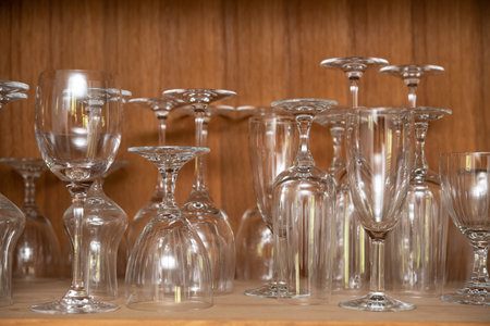 different wine glasses in wooden cabinetの写真素材