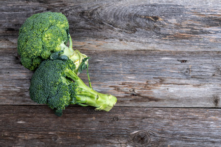 green broccoli on wooden boardの写真素材