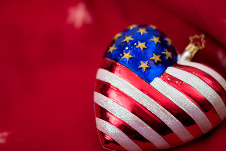 American flag Christmas ornament with red background の写真素材