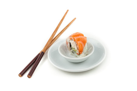 Salmon sushi on a plate with chopsticks on the sideの写真素材