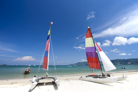 Beach chair and colorful umbrella on the beach in sunny day, Phuket Thailand の写真素材