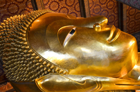 Reclining Buddha gold statue face  Wat Pho, Bangkok, Thailandのeditorial素材