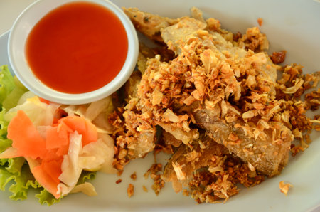 Stir in garlic and fish dishes.の写真素材