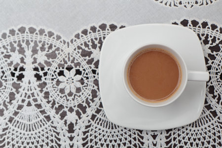 Coffee on the lace tableclothの写真素材