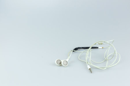 Broken earphone on white background.の写真素材