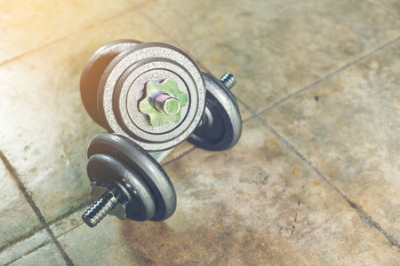 Twin Iron Dumbbells on the floor for home workout.の写真素材