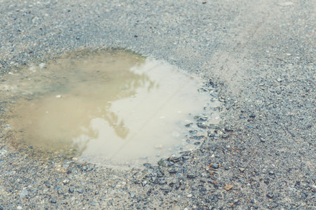 Puddle on ground after raining.の写真素材