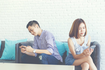 Women lovers using a smartphone for social addict and don't care their relationships.の写真素材