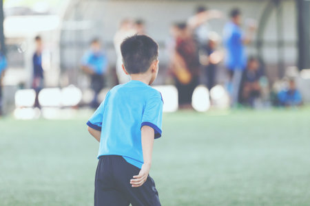 Young Asian football player in blue jersey between competition.の写真素材