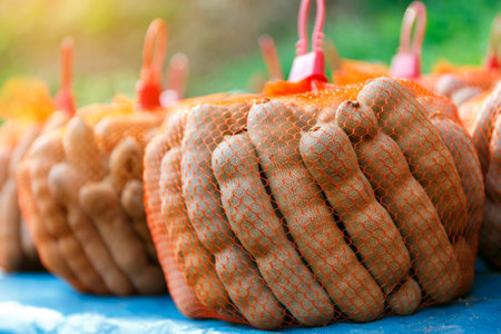 Thai ripe tamarind in the orange rope basket group for sale.の写真素材